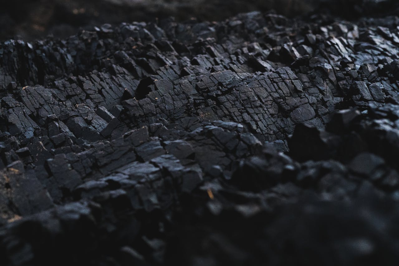 hero-img-02 A detailed close-up of dark charcoal texture, showcasing its rough and jagged surface.